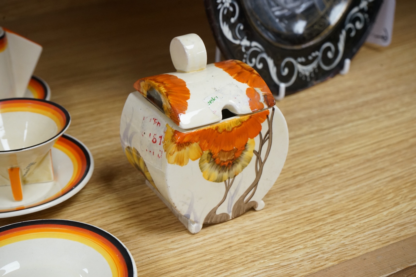 An Art Deco Clarice Cliff Bizarre part coffee set and a similar Rhodanthe-pattern preserve pot and cover, largest 11cm high